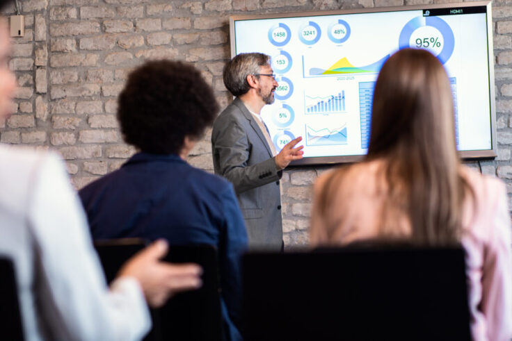 Middle age businessman holding presentation